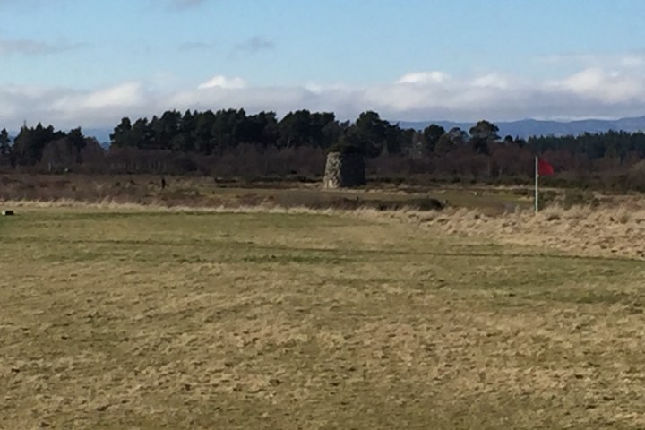 a person standing on a dry grass field