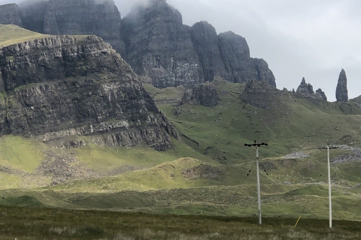 a field with a mountain in the background